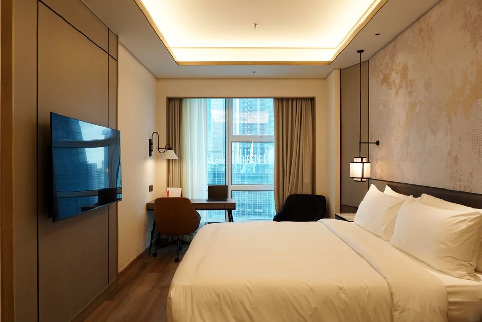 Cozy and stylish hotel room interior with city view in Jakarta, Indonesia.