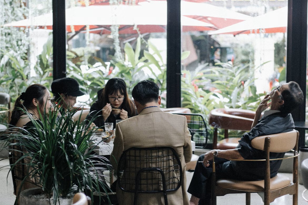 A group of people eating around a table.